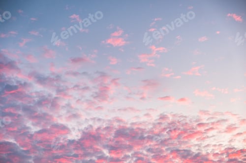 Preview: Colorful pink clouds on blue sky at dusk