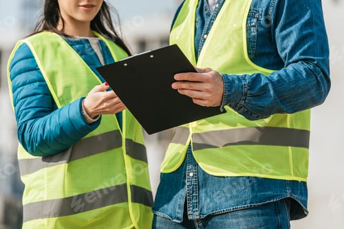 Preview: Cropped view of Surveyors in high visibility jackets holding clipboard