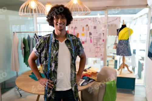 Preview: In studio, fashion designer smiling with colorful fabrics and sketches around, copy space