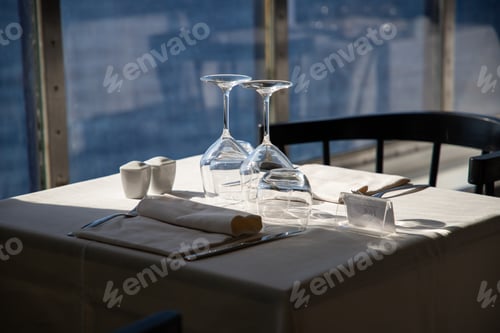 Preview: restaurant table and the sea in the background