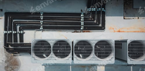 Preview: Air conditioner compressor on a building's rooftop.