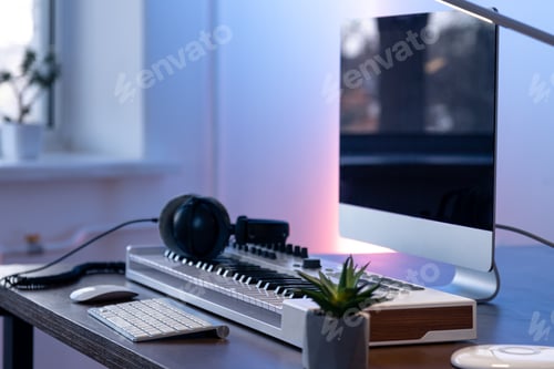 Preview: Computer, midi keyboard and headphones on the table, music creation concept.