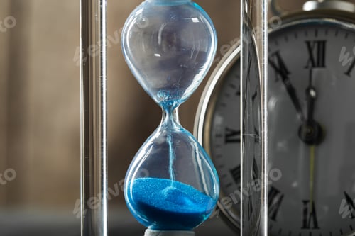 Preview: Time is passing. Blue hourglass close up