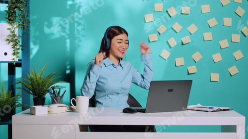 Preview: Businesswoman dancing and singing at work