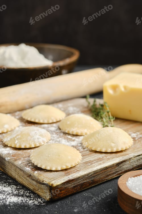 Preview: Homemade pasta preparation on a wooden surface with ingredients and tools