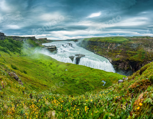 Preview: Gullfoss powerful waterfall flowing from Hvita river and moody sky in summer at Iceland