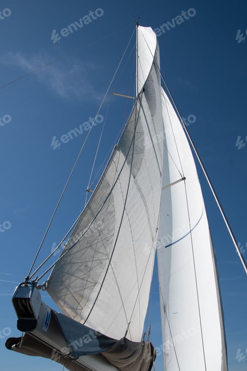 Preview: Vertical shot of a beautiful sailing boat against the blue sky