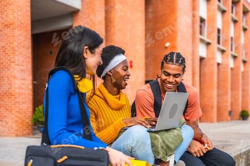 Preview: Diverse students laughing, collaborating, and studying outdoors using laptop