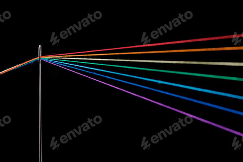Preview: multi-colored threads for sewing in the form of a rainbow pass through an antique needle