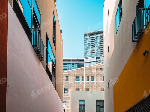 Preview: Low angle shot of modern buildings on a blue sky background