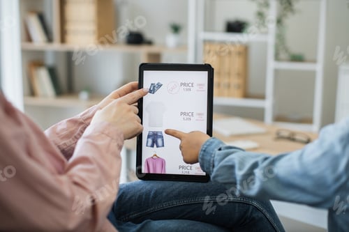 Preview: Close up of tablet with clothes webstore on screen