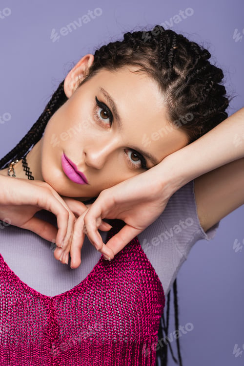 Preview: portrait of young woman with makeup posing with hands near face isolated on purple