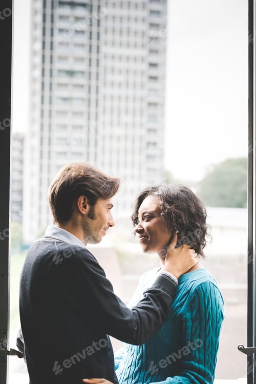 Preview: Romantic multiethnic couple indoor eye to eye