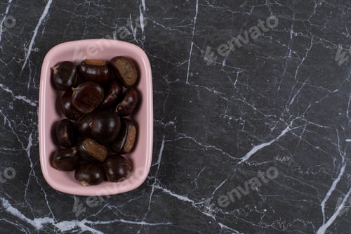 Preview: Chestnut in the pink bowl, on the marble background