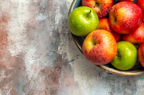 Preview: top half view red and green apples in bowl on nude background copy space