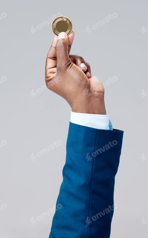 Preview: Studio shot of a businessman holding a bitcoin against a grey background
