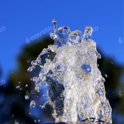 Preview: Water Fountain - Photograph Of Water Coming Up From The Top Of A Fountain With Trees And A Blue Sky