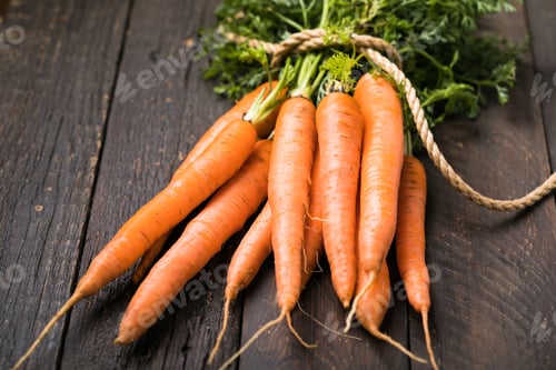 Preview: Fresh carrots bunch on rustic background. Healthy vegan vegetable food.