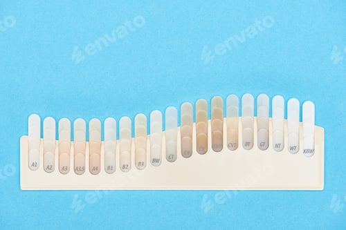 Preview: top view of teeth samples with different shades isolated on blue