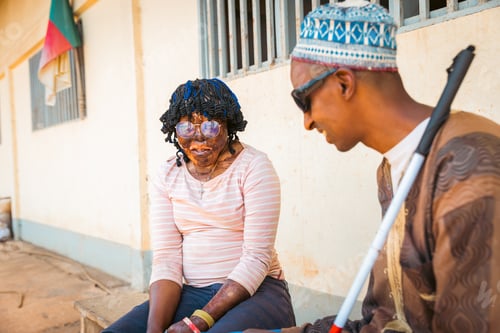 Preview: A man and a woman are sitting on a bench speaking, disabled people together