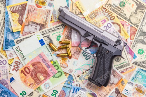 Preview: Handgun on various banknotes background. Top view.