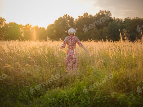 Preview: boho chic woman in a floral dress in European countryside