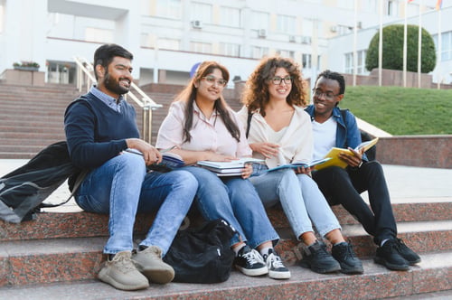 Preview: Diverse university students studying outdoors on campus steps