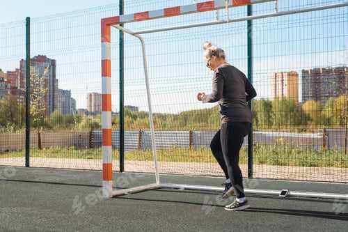 Preview: Woman in sportswear fitness outdoor training in summer. Fitness athlete jogging in place for weight