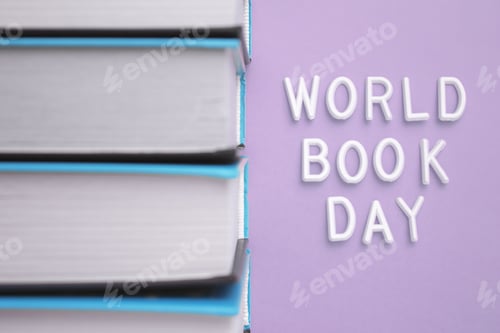 Preview: A stack of books with World Book Day in electric blue font