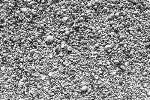 Preview: Large Grained Texture Of Damp Or Wet Sand For A Natural Abstract Background Of Monochrome Tone