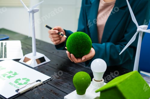 Preview: An Asian businesswoman sits at her desk, discussing clean energy solutions their impact on homes