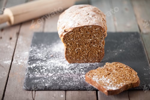 Preview: Fresh Irish soda bread with oat sliced on a slate cutting board Selective focus
