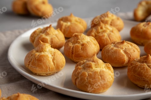 Preview: Homemade Mini Cream Puffs on a Plate, low angle view. Close-up.