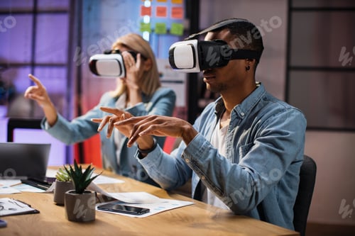 Preview: Company workers wearing VR headset during meeting