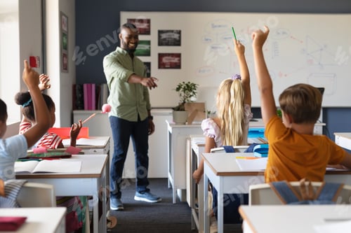 Preview: Enthusiastic Students Raise Hands in Classroom Setting