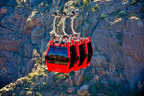 Preview: High angle shot of a red cabinet of a ropeway surrounded with rocky landscape