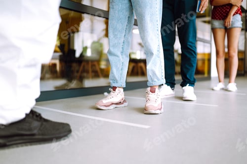 Preview: Crowd of people stand in line with social distancing. COVID-19. Safe social distancing practice.
