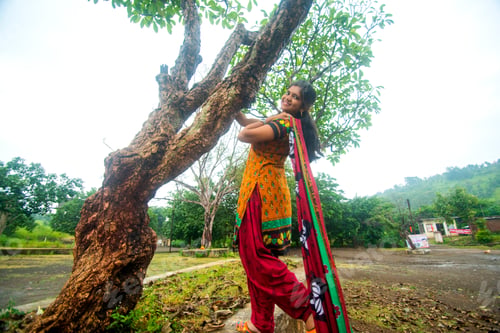 Preview: Young girl near tree trunk and she enjoying fresh air outdoors