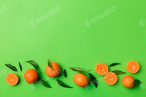 Preview: Many fresh ripe mandarin with green leaves on colored background, top view, space for text