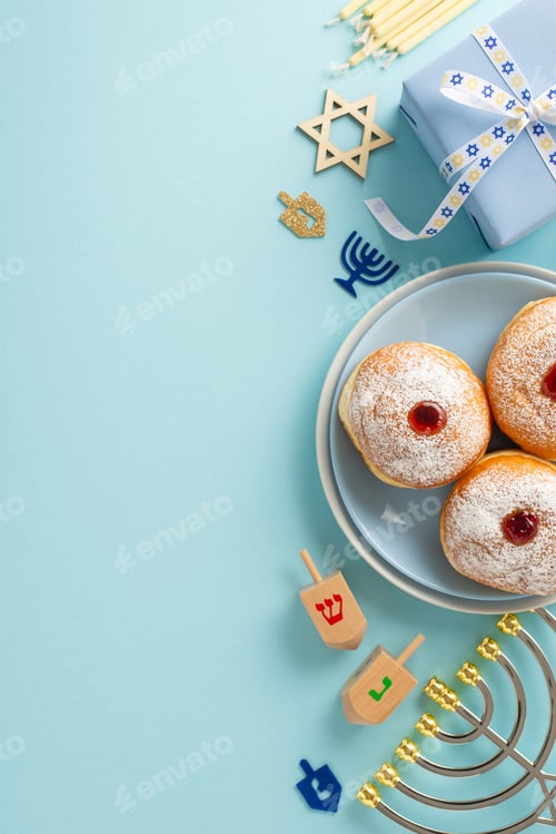 Preview: Hanukkah holiday meal arrangement. Top view vertical image of Jewish sufganiyot on plates