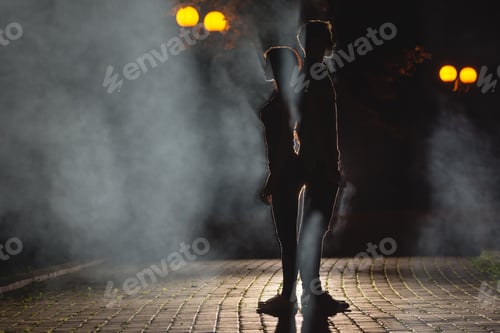 Preview: The man and woman stand on the smoky street. night time