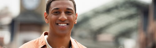 Preview: portrait of joyful african american man smiling at camera outdoors, banner