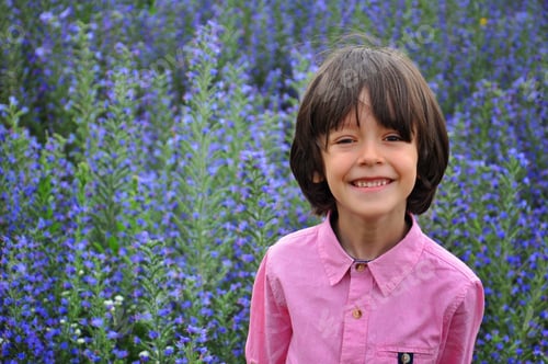 Preview: Attractive smiling kid boy in blue nature background