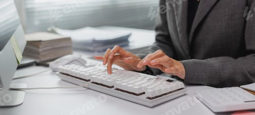 Preview: Person typing data on computer keyboard at office