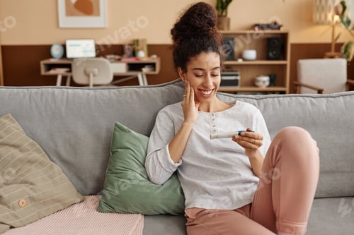 Preview: Woman with Curly Hair Looks At Pregnancy Test