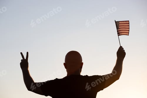 Preview: Man holding a waving american USA flag.
