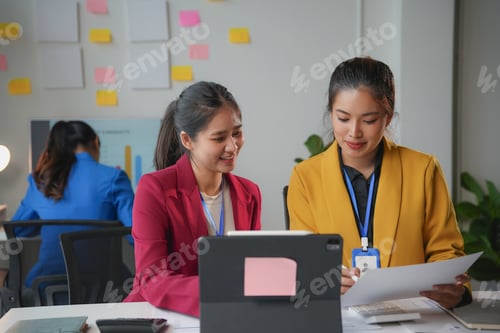 Preview: Two young businesswomen are working together in the office