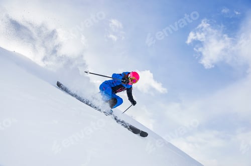 Preview: Skier in vibrant gear carving through fresh snow