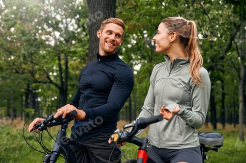 Preview: A Couple Happily Enjoying a Scenic Bike Ride Together Amidst Beautiful Nature Surroundings