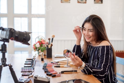 Preview: Young asian woman recording video makeup cosmetic at home. Selling products online.